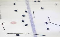 Tampa Bay Lightning gloves and sticks lie on the ice as the team celebrates their win over the Dallas Stars to win the Stanley Cup in the NHL Stanley Cup hockey finals, in Edmonton, Alberta, on Monday, Sept. 28, 2020. (Jason Franson/The Canadian Press via AP)