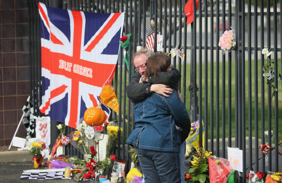 INDIANAPOLIS, IN - OCTOBER 17: Kevin and Karen Burris embrace at the gate to the Indianapolis Motor Speedway where tributes are being left by race fans in memory of two-time Indianapolis 500 winner Dan Wheldon on October 17, 2011 in Indianapolis, Indiana. Wheldon was killed in a crash yesterday at the Izod IndyCar series season finale at Las Vegas Motor Speedway. (Photo by Scott Olson/Getty Images)