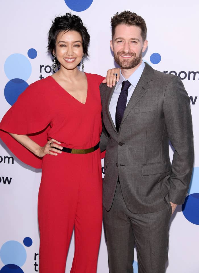 Renee and Matthew smiling and embracing on the red carpet