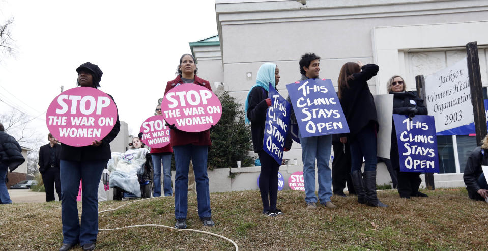 Abortion rights supporters stand outside the Jackson Women's Health Organization Inc., Mississippiís only commercial abortion clinic in Jackson, Miss., Tuesday, Jan. 22, 2013. Activists pro-and anti-abortion marked 40 years since a U.S. Supreme Court ruling established a nationwide right to abortion, with protests at the Capitol and at the clinic. (AP Photo/Rogelio V. Solis)