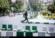 <p>A member of Iranian forces runs during an attack on the Iranian parliament in central Tehran, Iran, June 7, 2017. (Photo: Tasnim News Agency/Handout via Reuters) </p>