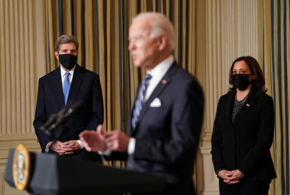 U.S. President Joe Biden delivers remarks on tackling climate change as White House climate envoy John Kerry and Vice President Kamala Harris listen in the State Dining Room at the White House in Washington, U.S., January 27, 2021. REUTERS/Kevin Lamarque