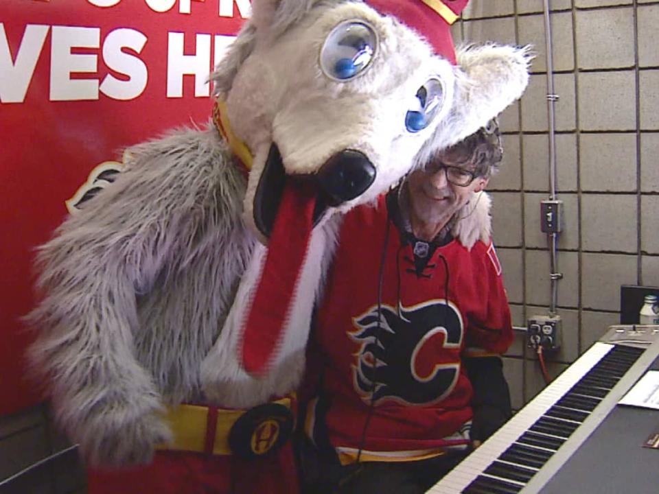 Willy Joosen, photographed with Harvey the Hound, at a Flames game in 2017. (Mike Symington/CBC - image credit)
