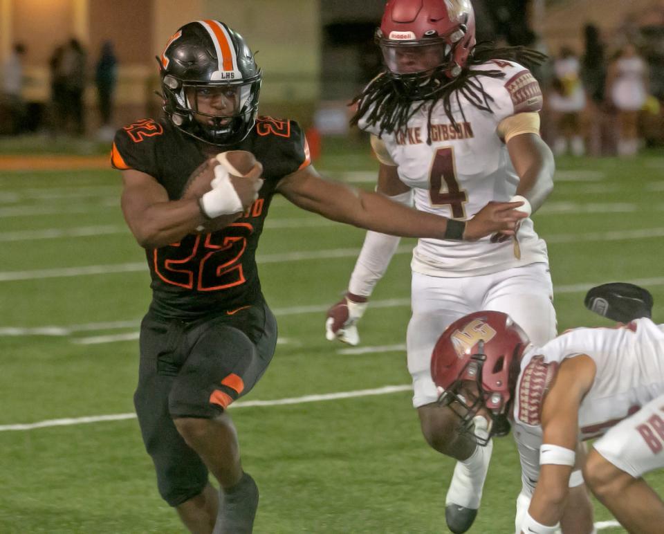 Lakeland High School running back Markel Johnson (22) rushes the ball against Lake Gibson High School during the third quarter of their Class 4S, Region 2, District 7 semifinal playoff game at Bryant Stadium Friday night. November 11, 2022