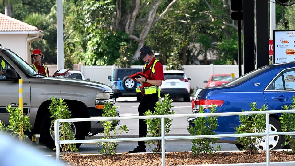 An employee takes the order of a driver at the new Chick-Fil-A, which opened as planned at the intersection of Manatee Avenue West and 43rd Avenue West Thursday despite not having completed a traffic deceleration lane on 43rd as promised by Chick-Fil-A.