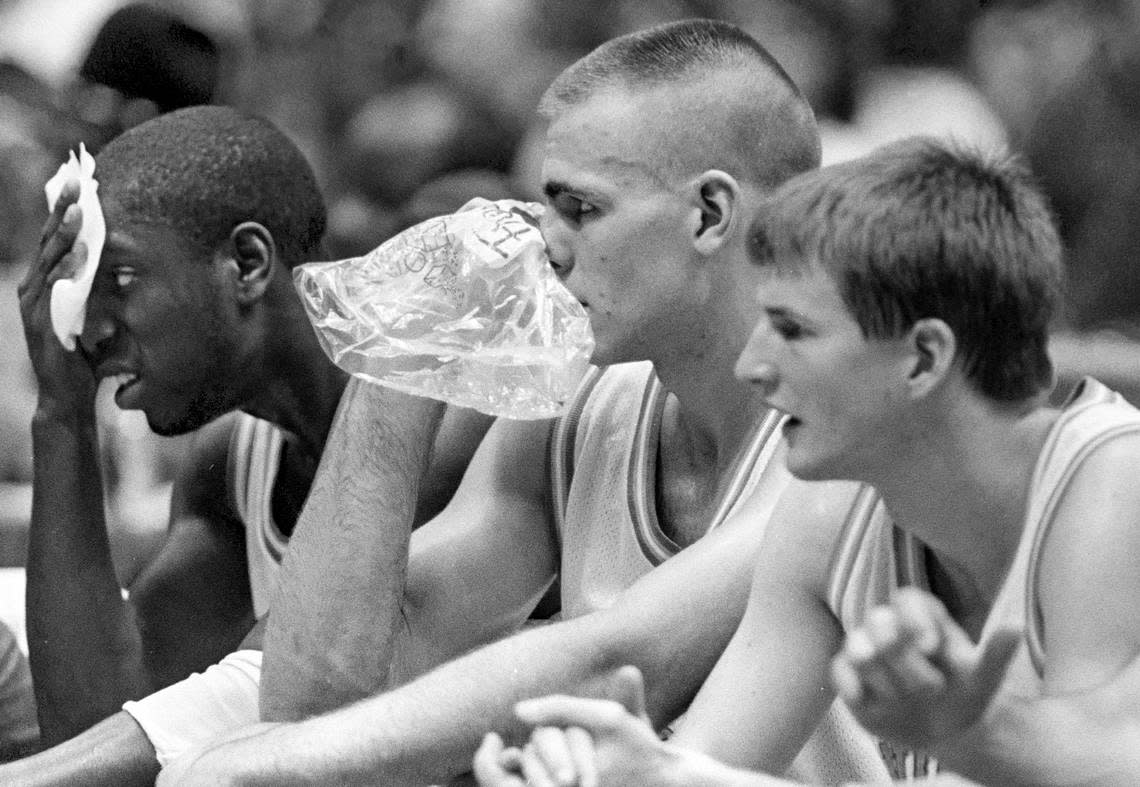 UNC center Eric Montross (center) holds ice to his face as forward Brian Reese holds a towel to his during a physical NCAA Tournament game.