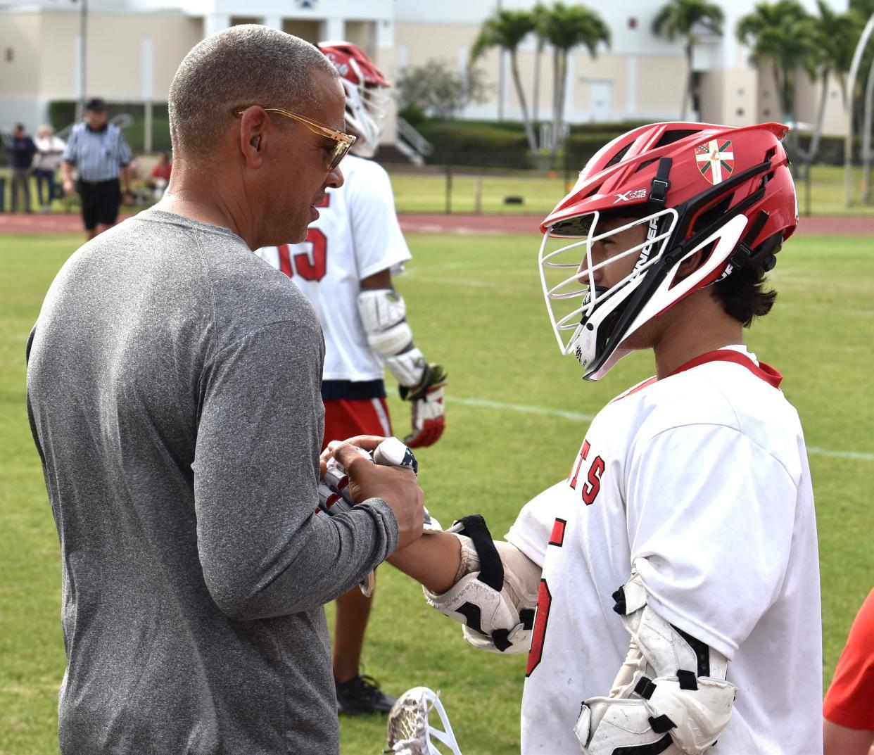 Saint Andrews' Nick Testa shares a handshake with Scots coach Chuck Miller during their game against Calvary Christian on April 11, 2024.