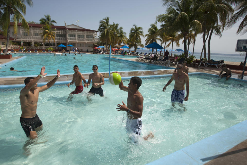 In this June 29, 2013 photo, tourist play pool basketball at Club Indigo beach resort in Montrouis, Haiti. The Haitian government is trying to revive the country’s long stagnant tourism industry with investments totaling more than $160 million. Haiti’s tourism ministry had about $2 million in its budget under the previous administration, and received another $1 million from a Venezuelan oil fund in the aftermath of a destructive storm season, according to the former tourism minister. Today, the department has a budget that’s $4.7 million, plus $27 million from Venezuela’s PetroCaribe fund. (AP Photo/Dieu Nalio Chery)