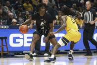Eastern Kentucky guard Curt Lewis (4) is defended by West Virginia guard Kedrian Johnson (0) during the first half of an NCAA college basketball game in Morgantown, W.Va., Friday, Nov. 26, 2021. (AP Photo/Kathleen Batten)
