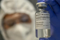 A bottle containing the drug Remdesivir is held by a health worker at the Institute of Infectology of Kenezy Gyula Teaching Hospital of the University of Debrecen in Debrecen, Hungary, Thursday Oct. 15, 2020. A large study led by the World Health Organization released on Friday, Oct. 16, 2020, suggests that the antiviral drug did not help hospitalized COVID-19 patients, in contrast to an earlier study that made the medicine a standard of care in the United States and many other countries. The results do not negate the previous ones, and the WHO study was not as rigorous as the earlier one led by the U.S. National Institutes of Health. But they add to concerns about how much value the pricey drug gives because none of the studies have found it can improve survival. (Zsolt Czegledi/MTI via AP)