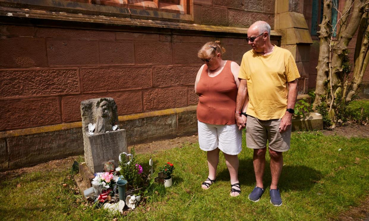 <span>Michelle and Richard Jones at St Ann’s church in Rainhill, Merseyside, where they recently discovered their son Christopher is buried.</span><span>Photograph: Christopher Thomond/The Guardian</span>