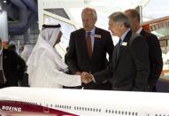 Sheikh Ahmed bin Saeed Al Maktoum, Chairman of Emirates Airlines, shakes hands with Boeing Commercial Airplanes Chief Executive Ray Conner (front R) as Boeing Chairman James McNerney (2nd L) looks on during the Dubai Airshow November 18, 2013. REUTERS/Caren Firouz
