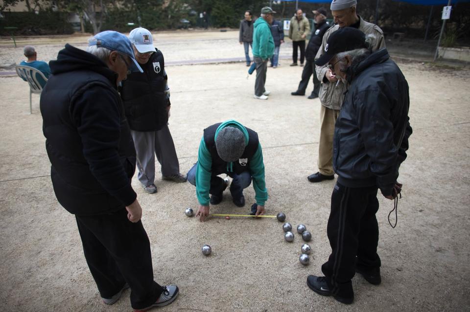 Members of the French community play boules at a club in Netanya, a city of 180,000 on the Mediterranean north of Tel Aviv, that has become the semi-official capital of the French community in Israel January 25, 2015. For Jews coming to "the Jewish state" from all corners reached by the diaspora, the move may bring relief, but it also raises challenges: a new language and culture, unfamiliar social codes and the difficulty of finding a job. With anti-Semitism rising in France, and their worries stoked by this month's killing of four Jews in a kosher supermarket in Paris, French Jews now make up the largest group of new migrants to Israel. Picture taken January 25, 2015. To match ISRAEL-MIGRATION/FRANCE REUTERS/Ronen Zvulun (ISRAEL - Tags: POLITICS SOCIETY IMMIGRATION SPORT)