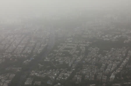 Buildings are seen blanketed by haze and dust in New Delhi, India, June 14, 2018. REUTERS/Danish Siddiqui