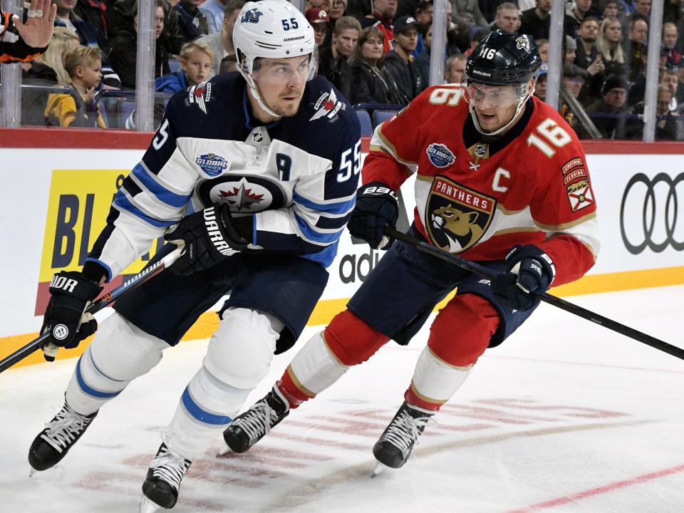 Finnish forward, team captain Aleksander Barkov, right, of Florida Panthers chases Mark Scheifele of Winnipeg Jets during the ice hockey NHL Global Series match between Florida Panthers vs Winnipeg Jets in Helsinki, Finland on Thursday, November 1, 2018. (Martti Kainulainen/Lehtikuva via AP)