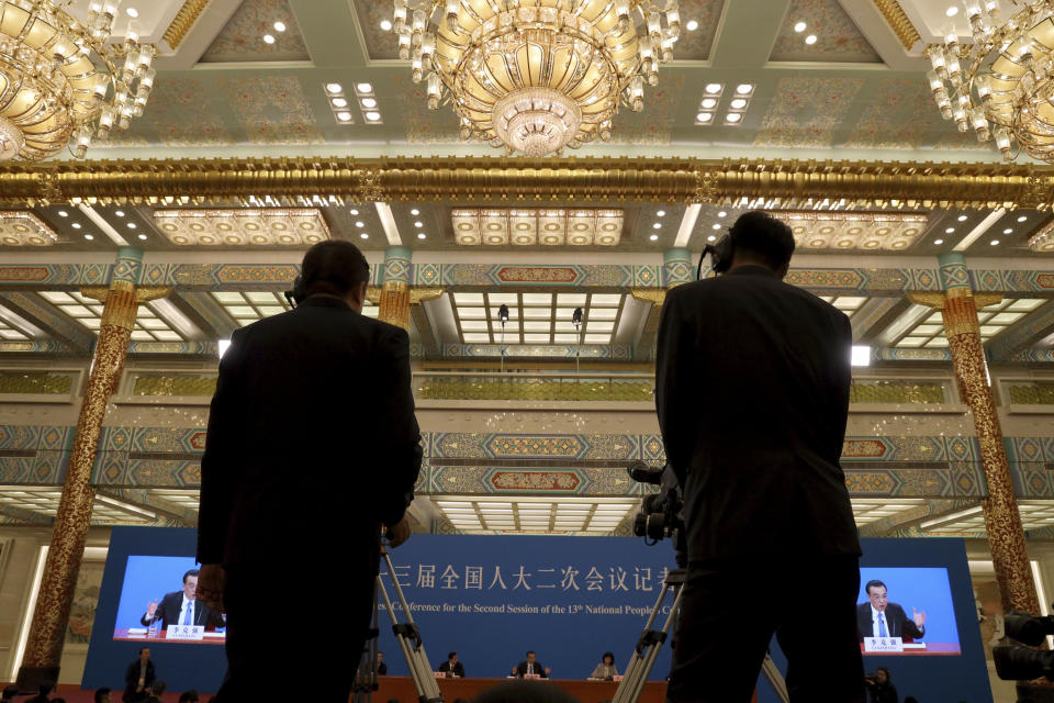 Chinese Premier Li Keqiang is displayed on screens during a press conference after the closing session of the National People's Congress in Beijing's Great hall of the People on Friday, March 15, 2019. (AP Photo/Ng Han Guan)