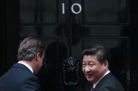 China's President Xi Jinping is welcomed by Britain's Prime Minister David Cameron to 10 Downing Street, in central London, Britain, October 21, 2015. Xi is on a state visit to Britain. REUTERS/Suzanne Plunkett