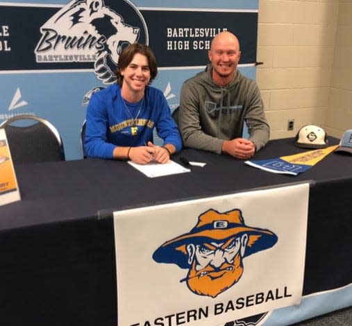 Bartlesville High senior baseball player Zeb Henry, left, inks his letter of intent to attend Eastern Oklahoma State and play baseball. Bartlesville head coach Cody Price joins him for the historic moment.