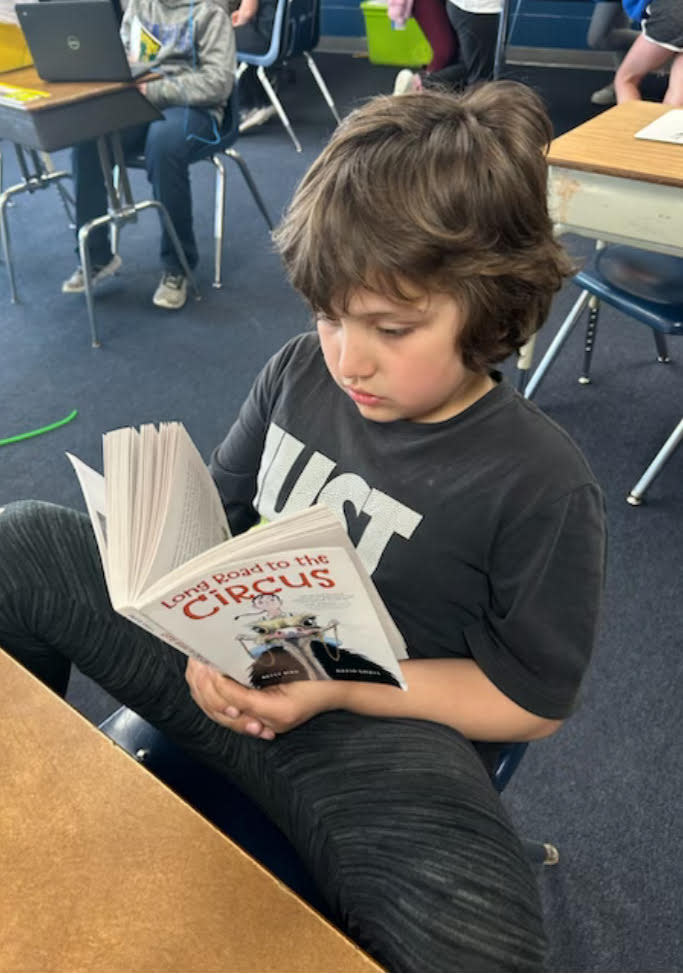 Burr Oak Elementary third-grade student Jaxzon Singleton spent free-reading time last week engaged in the book “Long Road to the Circus.” The story inspired organizers of the 2024 Burr Oak Heritage Festival to adopt a circus theme for this year’s community celebration.