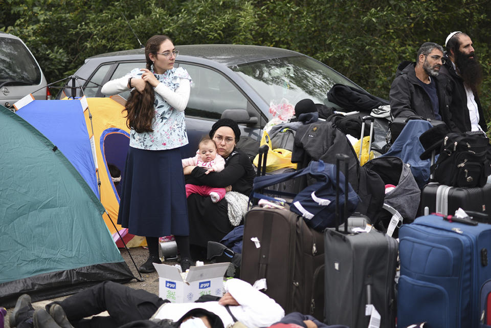 Jewish pilgrims gather on the Belarus-Ukraine border, in Belarus, Tuesday, Sept. 15, 2020. About 700 Jewish pilgrims are stuck on Belarus' border due to coroavirus restrictions that bar them from entering Ukraine. Thousands of pilgrims visit the city each September for Rosh Hashana, the Jewish new year. However, Ukraine closed its borders in late August amid a surge in COVID-19 infections. (TUT.by via AP)