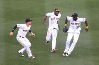 Jul 14, 2018; Pittsburgh, PA, USA; Pittsburgh Pirates left fielder Jordan Luplow (47) and center fielder Starling Marte (6) and right fielder Gregory Polanco (25) celebrate in the outfield after defeating the Milwaukee Brewers at PNC Park. Pittsburgh won 6-2. Mandatory Credit: Charles LeClaire-USA TODAY Sports