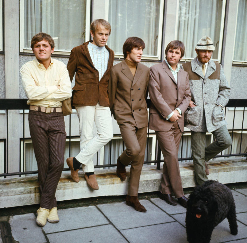 The Beach Boys leaning against a rail