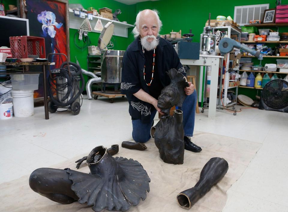 Sculptor Gary Henson, who made the Marjorie Tallchief statue that was stolen from the Tulsa Historical Society and cut up for scrap metal, shows the parts which he will reassemble at the Boys and Girls Club in Chelsea, Okla., on Monday, May 9, 2022. (Stephen Pingry/Tulsa World via AP)