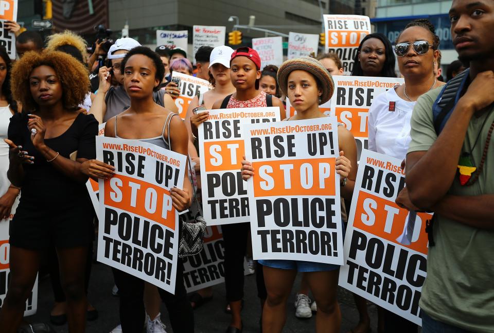 People hold banners and chant slogans as they march from Union Square Park to Grand Central in New York City.&nbsp;