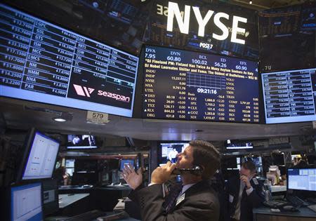 A trader looks up at a screen on the floor of the New York Stock Exchange at the market open in New York, October 14, 2013. REUTERS/Carlo Allegri