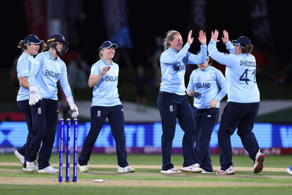 Sophie Ecclestone, third right, celebrates with teammates after bowling South Africa's Marizanne Kapp during their semifinal of the Women's Cricket World Cup cricket match in Christchurch, New Zealand, Thursday, March 31, 2022. (Martin Hunter/Photosport via AP)