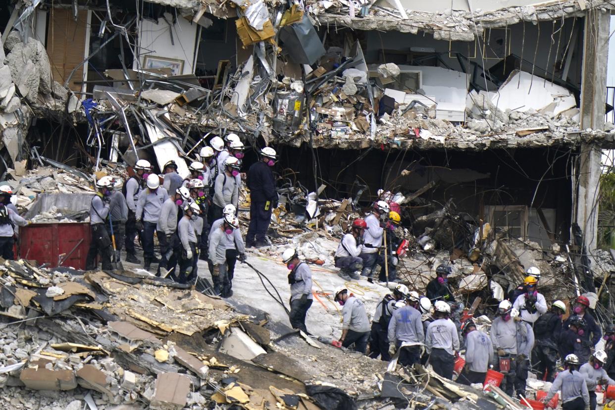 Rescue workers search in the rubble at the Champlain Towers South condominium on Monday, June 28, 2021, in the Surfside area of Miami. Many people are still unaccounted for after the building partially collapsed last Thursday.