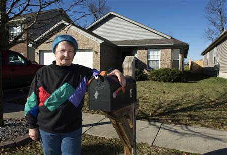 Ingrid Boak poses in front of her now-rented home in Lexington, Kentucky December 27, 2013. REUTERS/Tim Webb