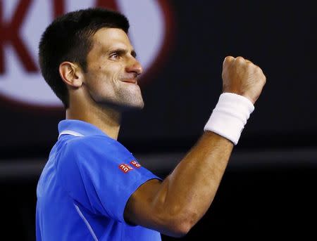 Novak Djokovic of Serbia celebrates after defeating Stan Wawrinka of Switzerland in their men's singles semi-final match at the Australian Open 2015 tennis tournament in Melbourne January 30, 2015. REUTERS/Issei Kato