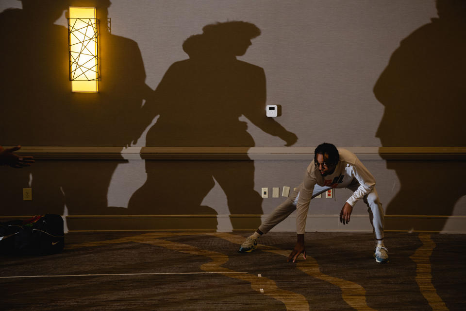 Tosan Evbuomwan stretches as the team practices in the ballroom at the Hyatt Regency Hotel in Louisville, Ky.<span class="copyright">Jon Cherry for TIME</span>