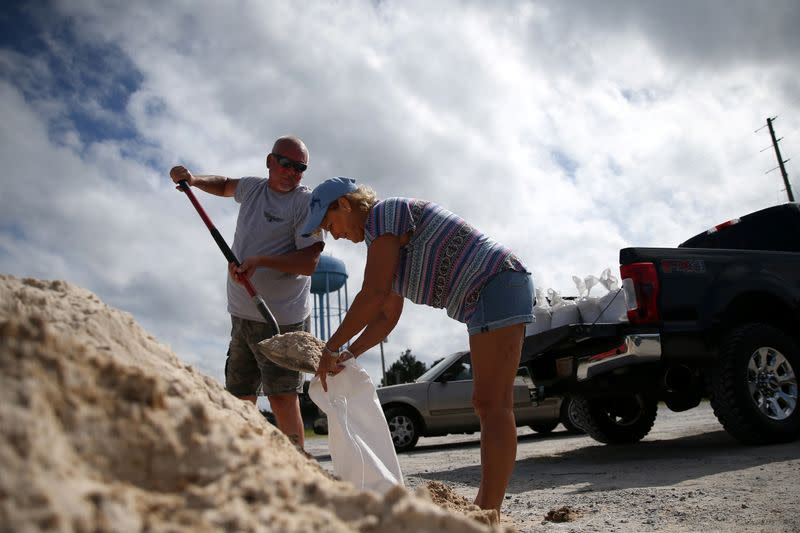 Rodney and Peggy Thomas fill sandbags as Tropical Storm Sally approaches in Bay St. Louis