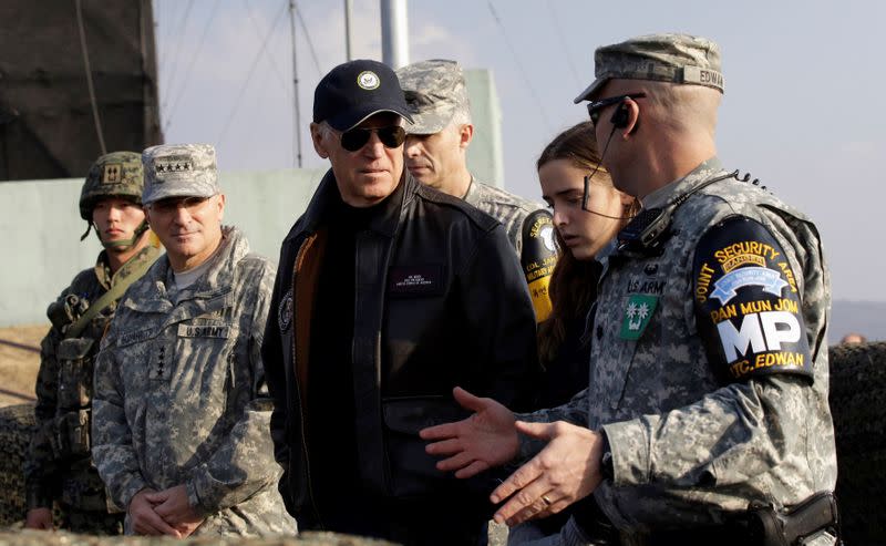 FILE PHOTO: U.S. Vice President Biden is briefed by Lt. Col. Edwan, the commander of the JSA Security Battalion at Observation Post Ouellette, during a tour of the DMZ, the military border separating the two Koreas, in Panmunjom
