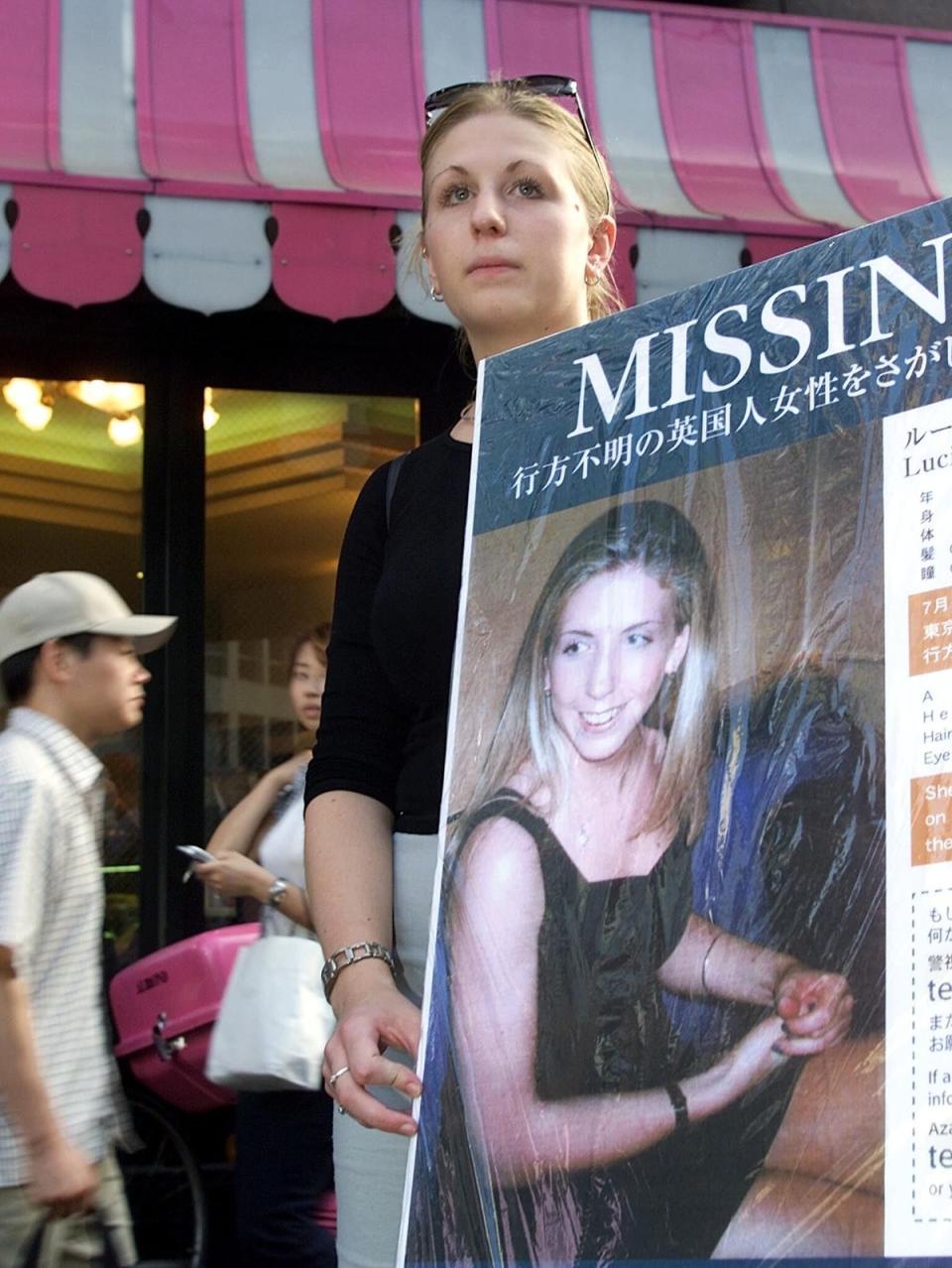 Lucie’s sister, Sophie, holds her missing poster (Getty)