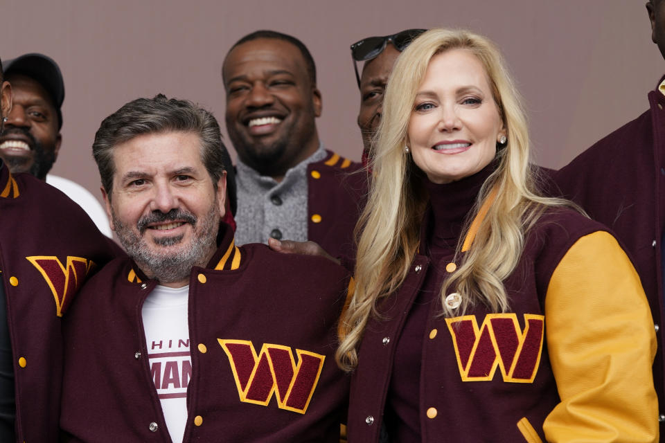 FILE - Dan and Tanya Snyder, co-owner and co-CEOs of the Washington Commanders, pose for photos after unveiling their NFL football team's new identity, Wednesday, Feb. 2, 2022, in Landover, Md. NFL owners unanimously approved the sale of the Washington Commanders on Thursday, July 2023, from Dan Snyder to a group led by Josh Harris and including Magic Johnson for a record $6.05 billion. (AP Photo/Patrick Semansky, File)