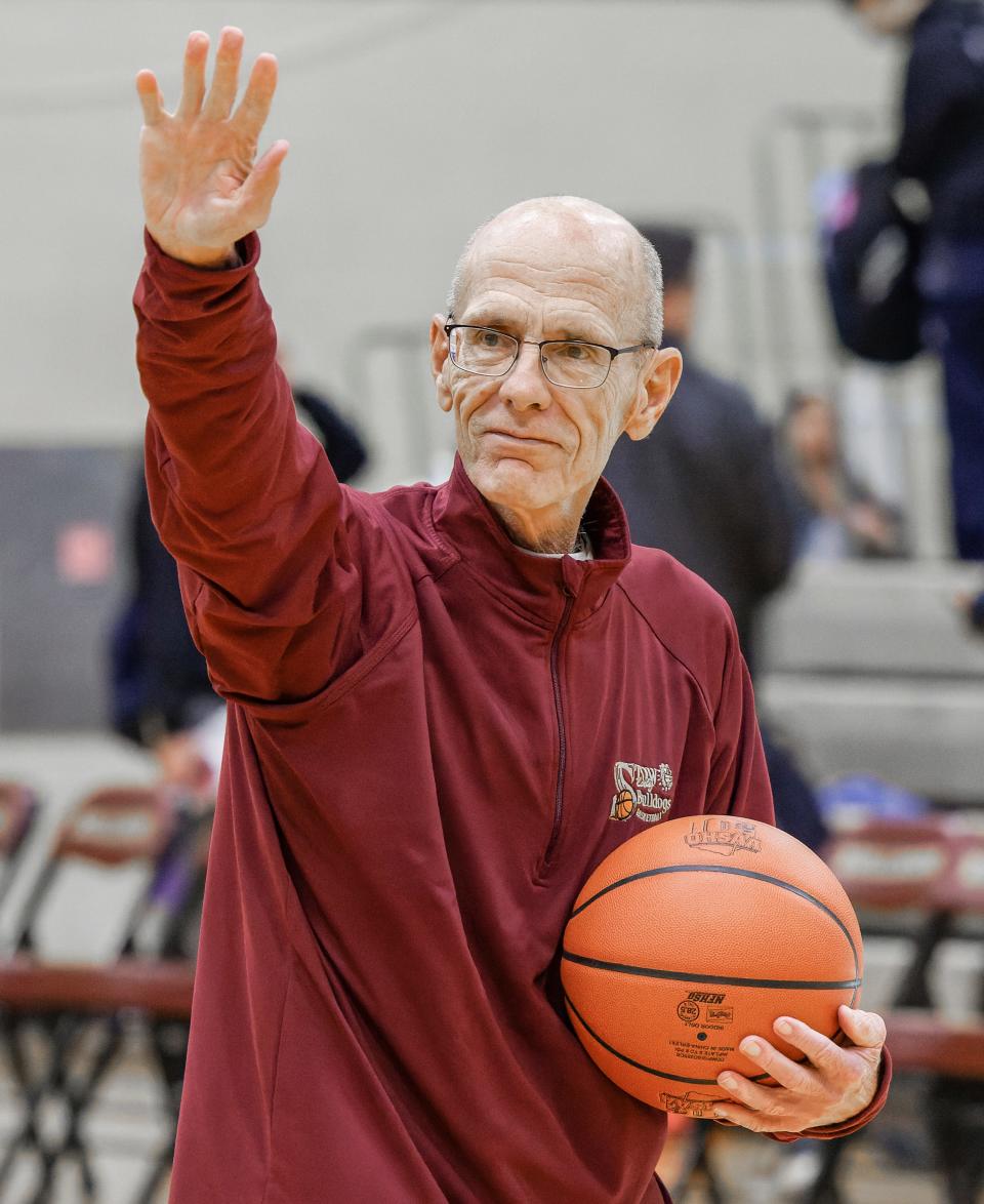 Stow-Munroe Falls girls basketball coach Bob Podges salutes the home crowd after securing career win No. 400 by beating Hudson earlier this season.