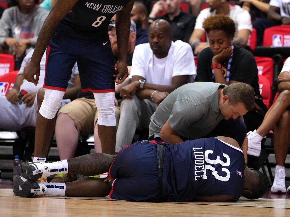 New Orleans Pelicans forward E.J. Liddell is evaluated after suffering a knee injury on Monday.