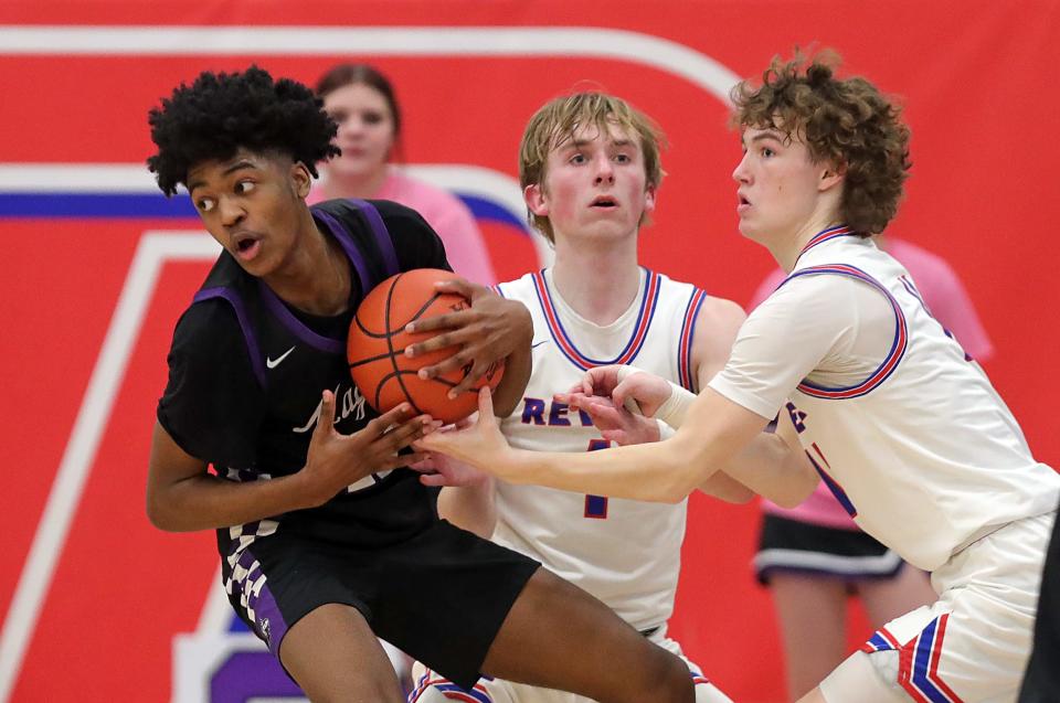 Barberton's Kameryn Kennerly, left, fights for the ball with Revere's Conner Groce during the second half of a high school basketball game, Tuesday, Feb. 13, 2024, in Richfield, Ohio.