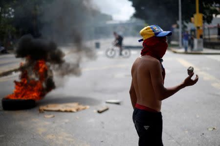 A demonstrator blocks a street during a strike called to protest against Venezuelan President Nicolas Maduro's government in Caracas, Venezuela, July 27, 2017 . REUTERS/Andres Martinez Casares