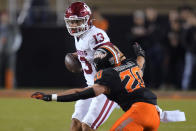 Oklahoma State linebacker Malcolm Rodriguez (20) moves in to sack Oklahoma quarterback Caleb Williams (13) during the first half of an NCAA college football game Saturday, Nov. 27, 2021, in Stillwater, Okla. (AP Photo/Sue Ogrocki)