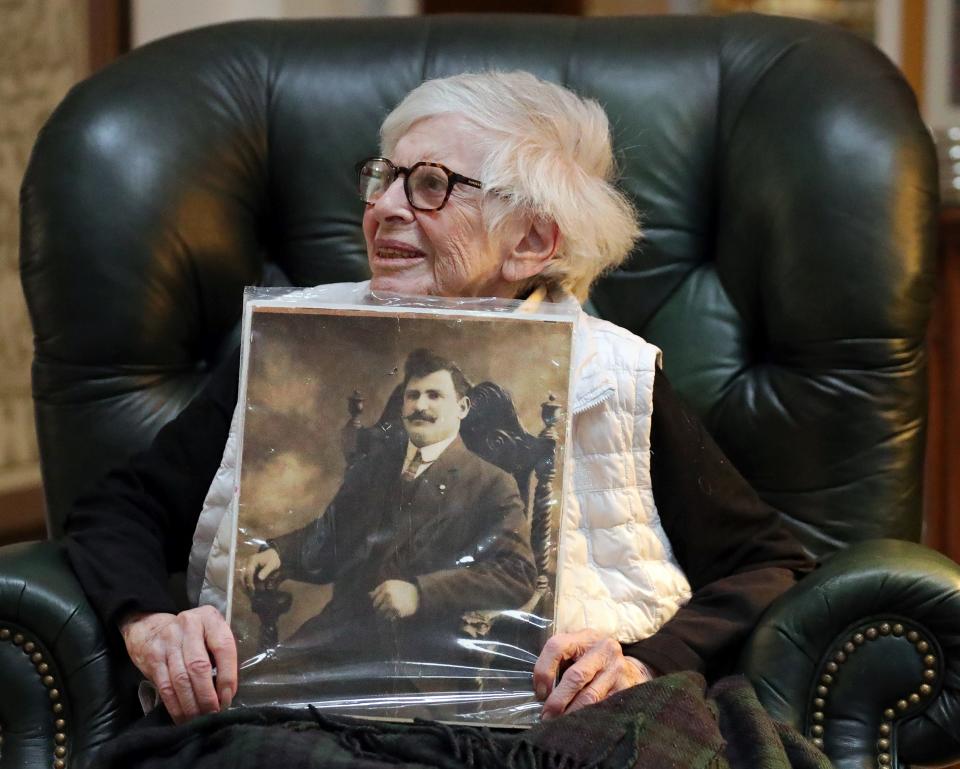 Mildred Neiman Korach holds up a portrait of her father, Louis Gershkowitz, Tuesday, Jan. 3, 2023, in Akron, Ohio.