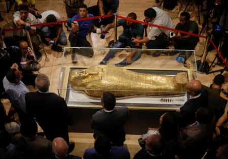 The Gold Coffin of Nedjemankh surrounded by members of media during a news conference to announce its return from the U.S. and display at the National Museum of Egyptian Civilization (NMEC) in Cairo