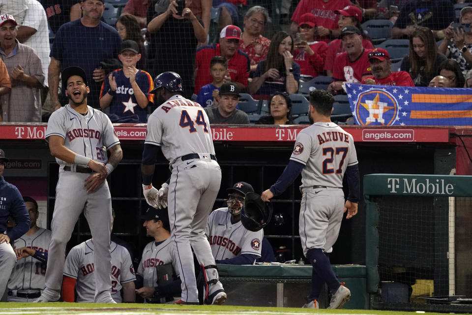 Houston Astros' Yordan Alvarez, center, celebrates with Jose Siri, left, and Jose Altuve after hitting a two-run home run during the first inning of a baseball game against the Los Angeles Angels Wednesday, Sept. 22, 2021, in Anaheim, Calif. (AP Photo/Mark J. Terrill)