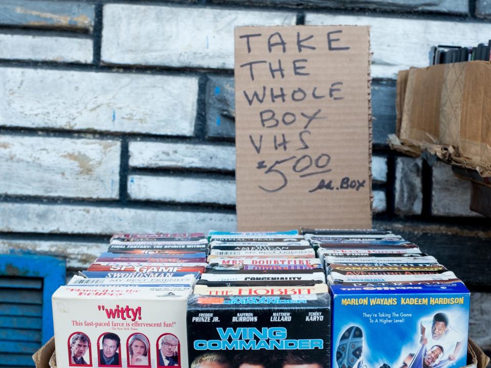 A box of VHS tapes up for sale for $5