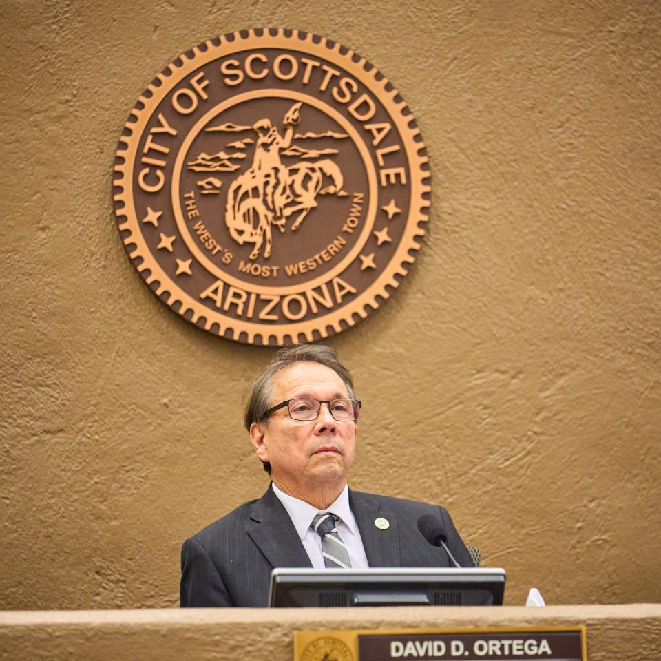 Scottsdale mayor David Ortega, sat underneath the seal of the City of Scottsdale, listens to public comments during a city council meeting at the Scottsdale Civic Center on Tuesday, Jan. 10, 2023.