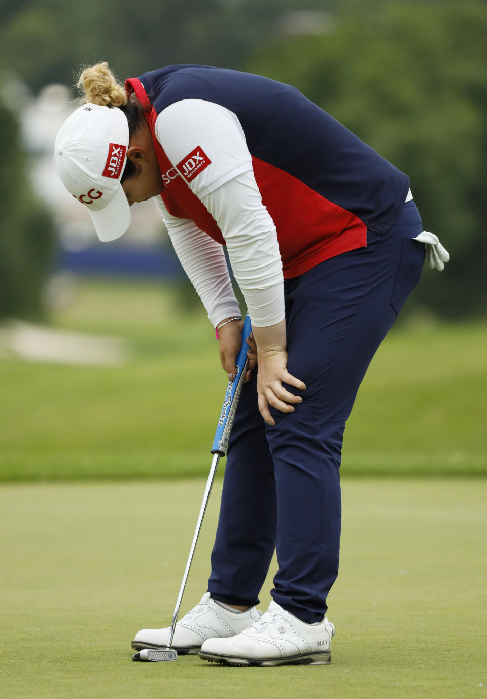 Ariya Jutanugarn, of Thailand, reacts after missing a putt on the 18th green during the third round of the KPMG Women's PGA Championship golf tournament, Saturday, June 22, 2019, in Chaska, Minn. (AP Photo/Charlie Neibergall)