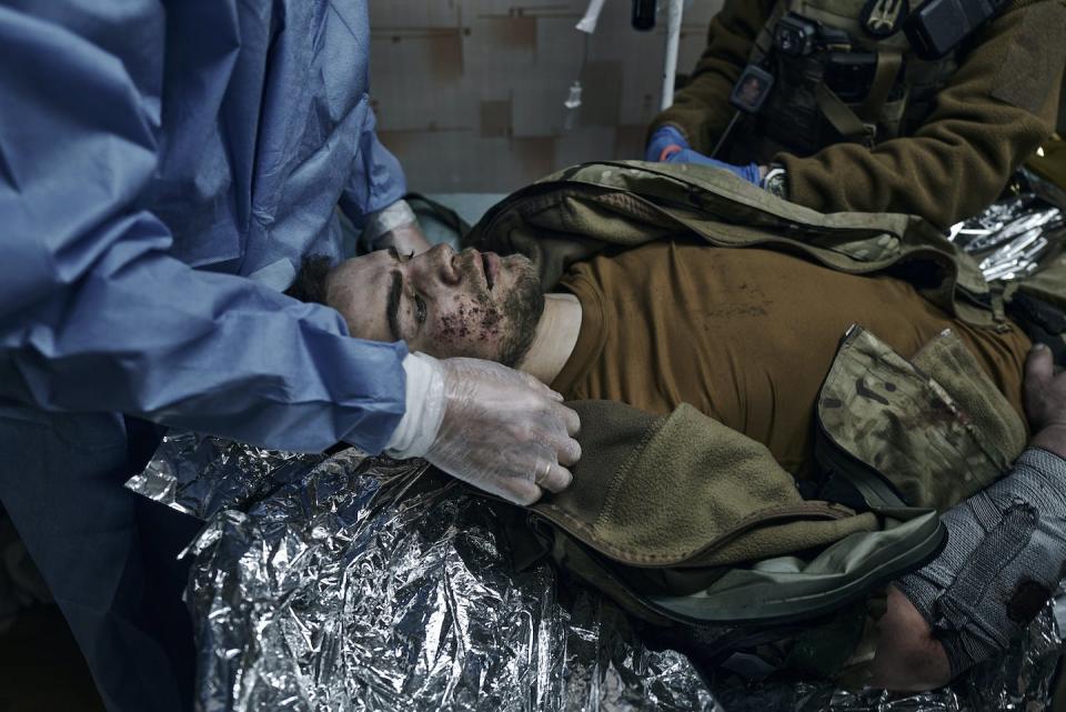 Military medics give first aid to a Ukrainian soldier wounded in a battle in Bakhmut. (AP Photo/Libkos)